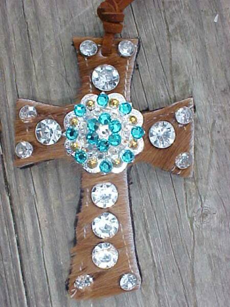 Reddish Brown Cow Hair On Hide Saddle Cross with Clear Crystals and a Silver and Gold Berry Concho with Teal and Clear Swarovski Crystals-